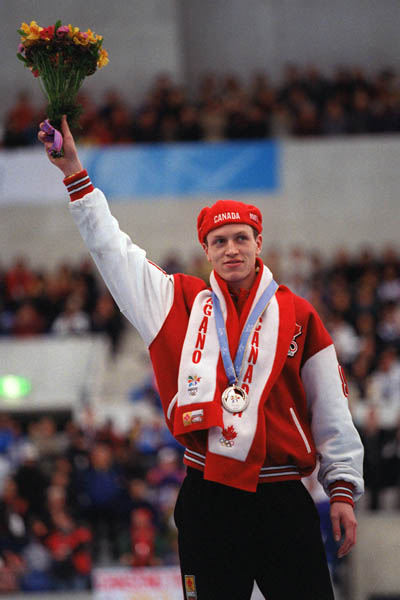 Canada's Jeremy Wotherspoon stands on the winners block after receiving a silver medal in the men's long track speed skating  at the 1998 Nagano Winter Olympics. (CP PHOTO/COA)