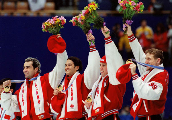 Canada's Francois Drolet, Derrick Campbell, Eric Bedard and Marc Gagnon celebrate  after winning the gold medal in the short track speed skating relay event at the 1998 Nagano Olympic Games . (CP Photo/ COA)