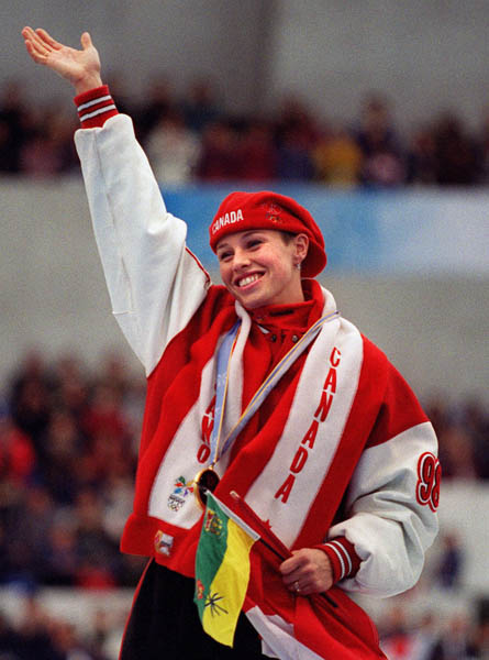 Canada's Catriona Le May Doan waves to the crowd from the winners block after winning a gold meal in the women's long track speed skating event at the 1998 Nagano Winter Olympics. (CP PHOTO/COA)