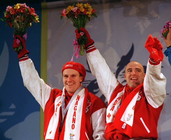 Canada's Pierre Leudes and Dave MacEachern on the winners podium after winning a gold meal in the bobsleigh event at the 1998 Nagano Winter Olympics. (CP PHOTO/COA)