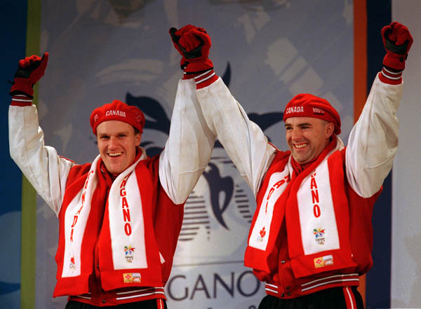 Canada's Pierre Lueders and Dave MacEachern show their excitement after winning a gold medal in the bobsleigh event at the 1998 Nagano Winter Olympics. (CP PHOTO/COA)