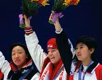 Canada's Annie Perreault stands on the winners podium after winning a gold medal in the women's short track speed skating event at the 1998 Nagano Winter Olympics. (CP PHOTO/COA)