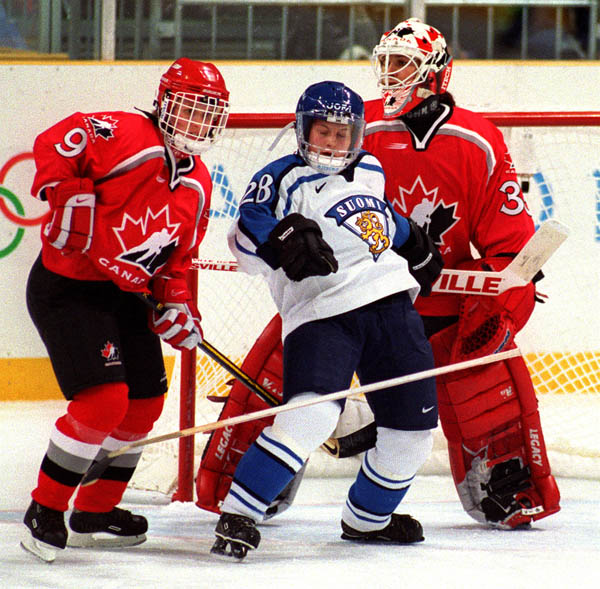 Canada's Fiona Smith and Manon Rheaume in action against their opponent at the 1998 Nagano Winter Olympics. (CP PHOTO/COA)