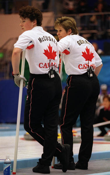 Canada's Joan McCusker and Marcia Gudereit watch as their opponents play their turn during a curling match at the 1998 Nagano Winter Olympics. (CP PHOTO/COA)