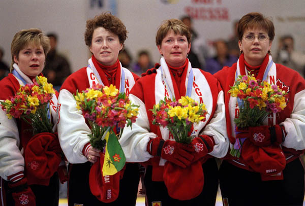 Canada's women's curling team (left to right) Marcia Gudereit, Joan McCusker, Jan Betkerand Sandra Schmirler show their emotion after winning a gold medal in the curling event at the1998 Nagano Olympic Games. (CP Photo/ COA)