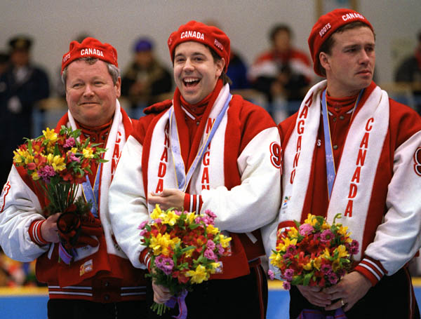 Canada's Men's curling team from left to right; Paul Savage, George Karrys and Collin Mitchell stand on the winners podium after winning the bronze medal  at the 1998 Nagano Winter Olympics. (CP PHOTO/COA)