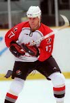 Canada's Rod Brind'Amour (17) is checked in the boards during hockey action against the United States at the 1998 Winter Olympics in Nagano. (CP Photo/COA/ F. Scott Grant )