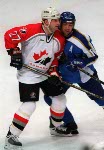 Canada's Shayne Corson (27) checks a Belarus player during hockey action at the 1998 Winter Olympics in Nagano. (CP Photo/COA/ F. Scott Grant )