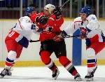 Canada's Shayne Corson (27) checks a Belarus player during hockey action at the 1998 Winter Olympics in Nagano. (CP Photo/COA/ F. Scott Grant )
