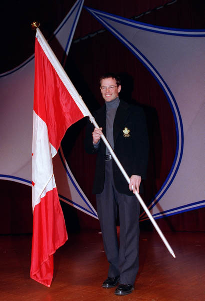 Canada's Jean-Luc Brassard with the Canadian Flag at the 1998 Nagano Winter Olympics. (CP PHOTO/COA)