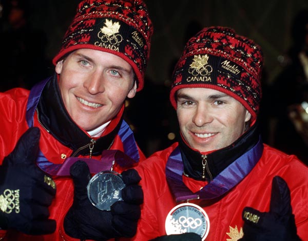 Canada's Phillipe Laroche (L) and Lloyd Langlois show off the medals they won in the men's freestyle ski event at the 1994 Lillehammer Winter Olympics. (CP PHOTO/ COA)