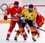 Canada's Brad Schlegel (left), Corey Hirsch (goalie) and Mark Astley compete in hockey action against Sweden at the 1994 Winter Olympics in Lillehammer. (CP Photo/COA/Claus Andersen)