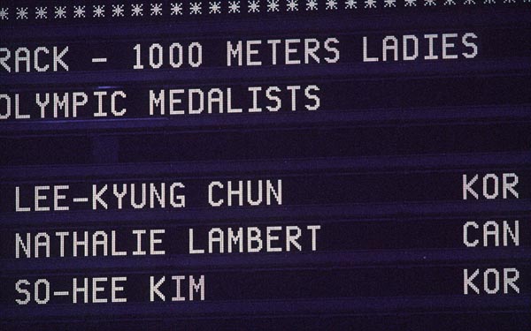 The 1,000 metres short-track speed skating medal winners, including silver medallist Canada's Nathalie Lambert, are posted on a scoreboard at the 1994 Lillehammer Winter Olympics. (CP PHOTO/ COA)