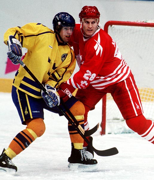 Canada's David Harlock in action against Sweden at the 1994 Lillehammer Winter Olympics. (CP PHOTO/ COA)