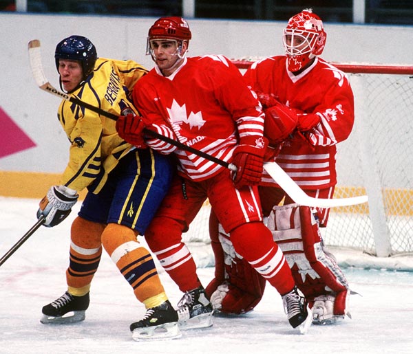 Canada's Ken Lovsin and goalie Corey Hirsch in action against Sweden at the 1994 Lillehammer Winter Olympics. (CP PHOTO/ COA)
