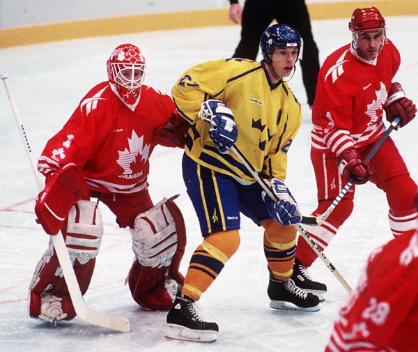 Canada's Corey Hirsch and Derek Mayer in action against Sweden at the 1994 Lillehammer Winter Olympics. (CP PHOTO/COA)