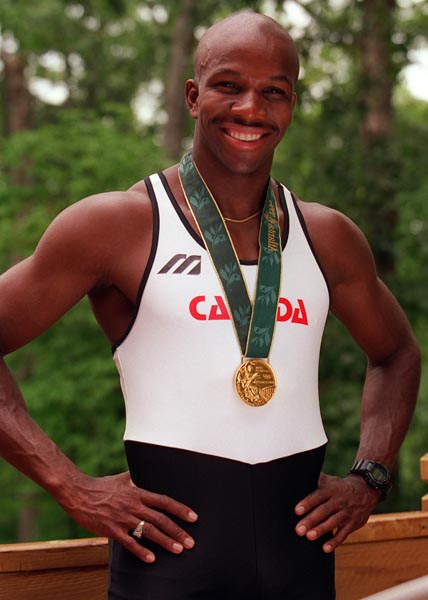 Canada's Donovan Bailey celebrates the gold medal he won for the men's 100m at the 1996 Atlanta Summer Olympic Games(CP PHOTO/COA/Claus Andersen)
