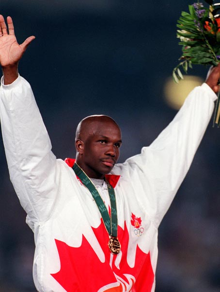 Canada's Donovan Bailey celebrates the gold medal he won for the men's 100m at the 1996 Atlanta Summer Olympic Games. (CP PHOTO/COA/Claus Andersen)