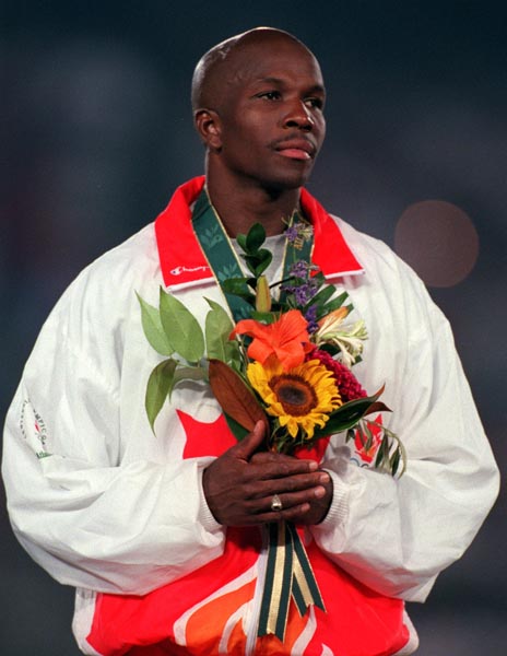 Canada's Donovan Bailey celebrates the gold medal he won for the men's 100m at the 1996 Atlanta Summer Olympic Games. (CP PHOTO/COA/Claus Andersen)
