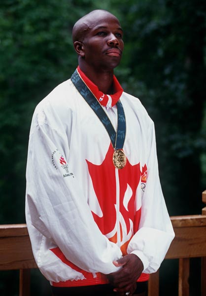 Canada's Donovan Bailey with the gold medal he won for the men's 100m event at the 1996 Atlanta Summer Olympic Games.(CP PHOTO/COA/Claus Andersen)