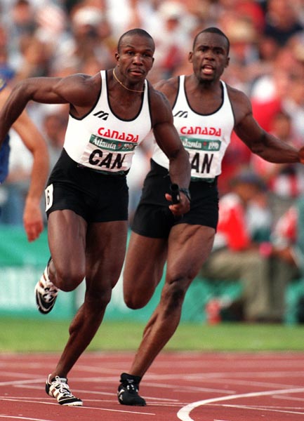 Canada's Donovan Bailey (left) and Bruny Surin competing in the men's 4x100m relay at the 1996 Atlanta Summer Olympic Games.(CP PHOTO/COA/Claus Andersen)