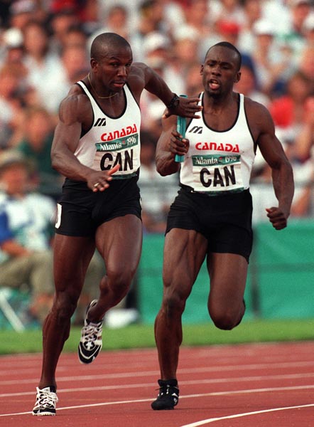 Canada's Donovan Bailey (left) and Bruny Surin competing in the men's 4x100m relay at the 1996 Atlanta Summer Olympic Games.(CP PHOTO/COA/Claus Andersen)