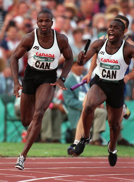 Canada's Donovan Bailey (left) and Bruny Surin competing in the 4x100m men's relay at the 1996 Atlanta Summer Olympic Games.(CP PHOTO/COA/Claus Andersen)