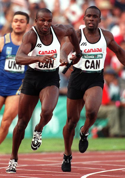 Canada's Donovan Bailey (foreground) and Bruny Surin competing in the men's 4x100m relay at the 1996 Atlanta Summer Olympic Games.(CP PHOTO/COA/Claus Andersen)