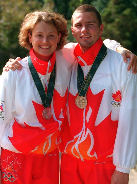 Canada's Marianne Limpert and Curtis Myden celebrate after winning gold and silver medals in the swimming event at the 1996 Atlanta Olympic Games. (CP Photo/ COA/Mike RIdewood)