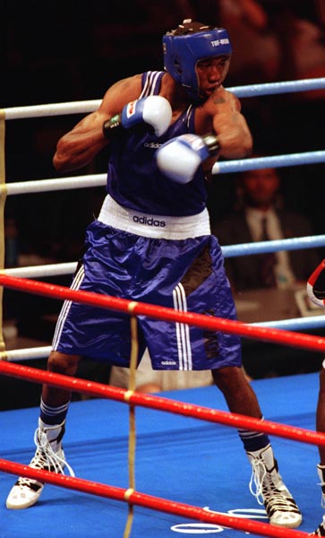 Canada's David Defiagbon in action boxing against his opponent at the 1996 Atlanta Summer Olympic Games. (CP PHOTO/COA/Scott Grant)