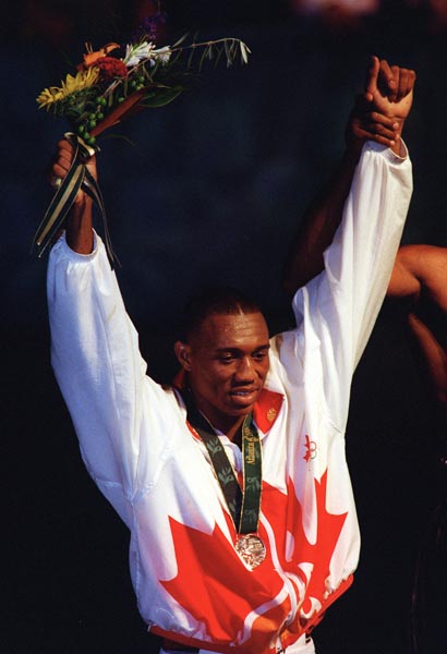 Canada's David Defiagbon celebrates the silver medal he won in the boxing event at the 1996 Atlanta Summer Olympic Games. (CP PHOTO/COA/Claus Andersen)