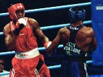 Canada's David Defiagbon (red) in action boxing against his opponent Felix Savon of Cuba at the 1996 Atlanta Summer Olympic Games. (CP PHOTO/COA/Mike Ridewood)