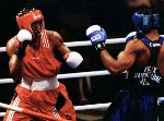 Canada's David Defiagbon (blue) in action boxing against his opponent at the 1996 Atlanta Summer Olympic Games. (CP PHOTO/COA/Scott Grant)
