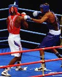 Canada's David Defiagbon (blue) in action boxing against his opponent at the 1996 Atlanta Summer Olympic Games. (CP PHOTO/COA/Scott Grant)