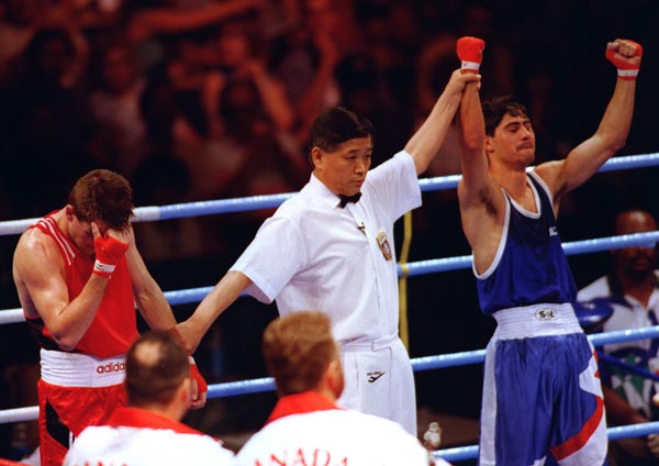 Canada's Mike Strange (right) boxing at the 1996 Atlanta Summer Olympic Games. (CP PHOTO/COA/Scott Grant)