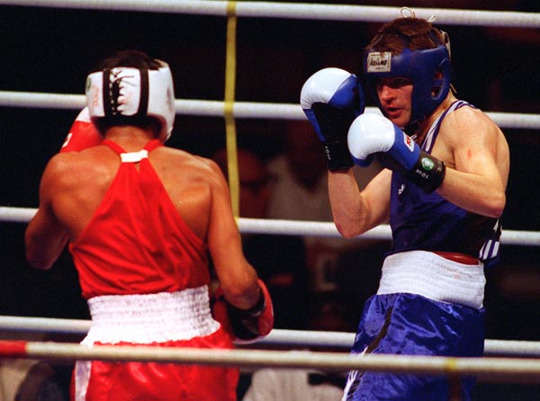 Canada's Mike Strange (blue) boxing at the 1996 Atlanta Summer Olympic Games. (CP PHOTO/COA/Scott Grant)
