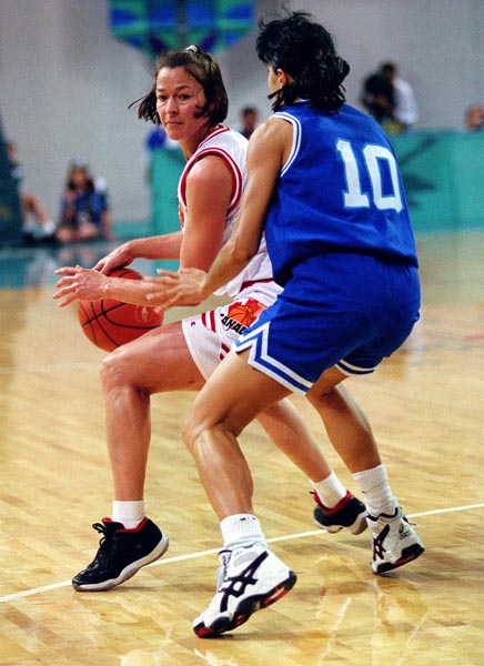Canada's Karla Karch (white jersey) in action against Italy during the women's basketball event at the 1996 Atlanta Summer Olympic Games. (CP PHOTO/COA/Mike Ridewood)