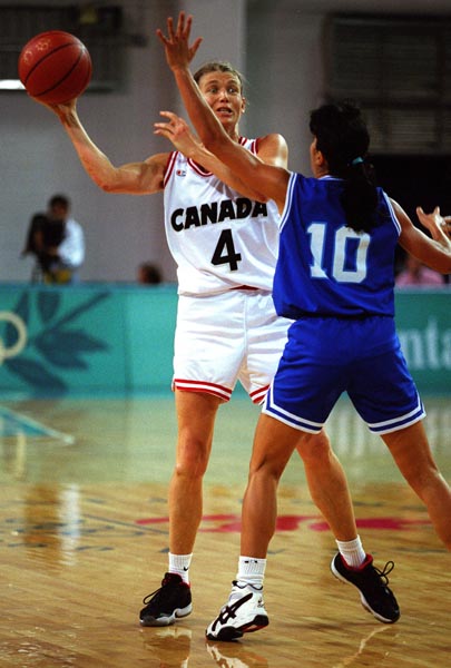 Canada's  Bev Smith (white jersey) playing women's basketball at the 1996 Atlanta Summer Olympic Games. (CP PHOTO/COA/Scott Grant)