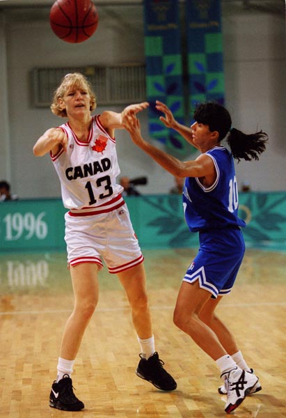 Canada's Kelly Boucher (white jersey) playing women's basketball at the 1996 Atlanta Summer Olympic Games. (CP PHOTO/COA/Mike Ridewood)