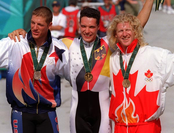 Canada's Curt Harnett (right) celebrates the bronze medal he won for the sprint cycling event at the 1996 Atlanta Summer Olympic Games. (CP PHOTO/COA/Mike Ridewood)