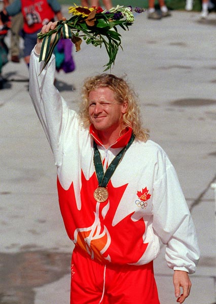 Canada's Curt Harnett celebrates the bronze medal he won for the sprint cycling event at the 1996 Atlanta Summer Olympic Games. (CP PHOTO/COA/Mike Ridewood)