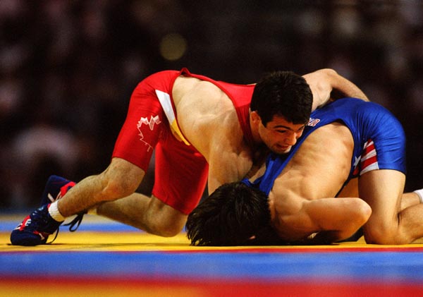 Canada's Guivi Sissaouri (red) competing in the wrestling event at the 1996 Atlanta Summer Olympic Games. (CP PHOTO/COA/Mike Ridewood)