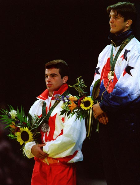 Canada's Guivi Sissaouri celebrates the silver medal he won in the Wrestling event at the 1996 Atlanta Summer Olympic Games. (CP PHOTO/COA/Scott Grant)