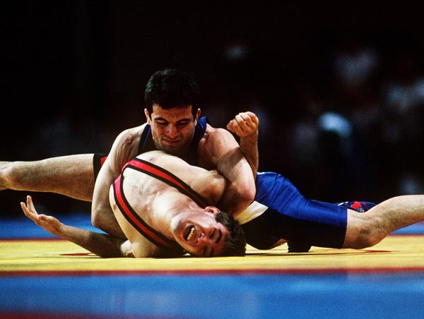 Canada's Guivi Sissaouri (top) competing in the wrestling event at the 1996 Atlanta Summer Olympic Games. (CP PHOTO/COA/Claus Andersen)