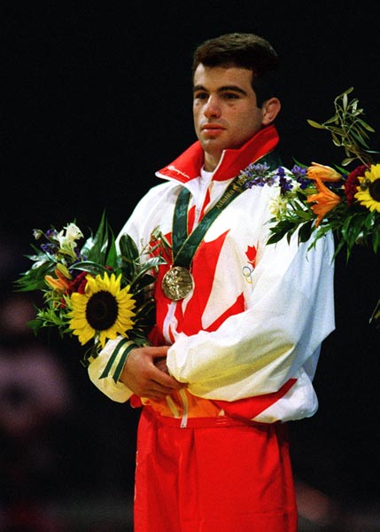 Canada's Guivi Sissaouri celebrates the silver medal he won in the wrestling event  at the 1996 Atlanta Summer Olympic Games. (CP PHOTO/COA/Mike RIdewood)