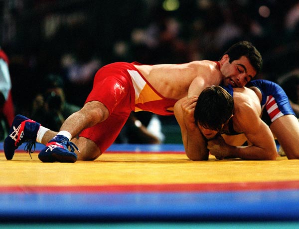Canada's Guivi Sissaouri (top) competing in the wrestling event at the 1996 Atlanta Summer Olympic Games. (CP PHOTO/COA/Mike Ridewood)