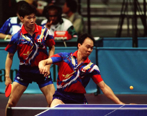 Canada's Johnny Huang (l) and Joe Ng  in action against their opponents during the table tennis event at the 1996 Atlanta Summer Olympic Games. (CP PHOTO/COA/Scott Grant)