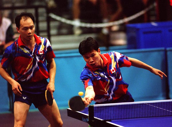 Canada's Johnny Huang (right) and Joe Ng  in action against their opponents during the table tennis event at the 1996 Atlanta Summer Olympic Games. (CP PHOTO/COA/Scott Grant)