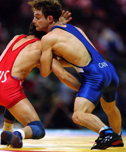 Canada's Paul Ragusa (blue) competing in the wrestling event at the 1996 Atlanta Summer Olympic Games. (CP PHOTO/COA/Claus Andersen)