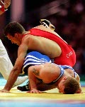 Canada's Craig Roberts (blue) competing in the wrestling event at the 1996 Atlanta Summer Olympic Games. (CP PHOTO/COA/Claus Andersen)